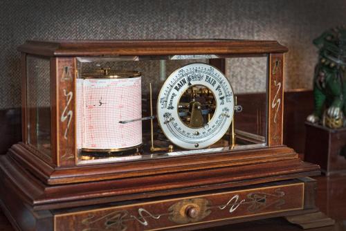 a wooden clock sitting on top of a table at Douneside House in Tarland