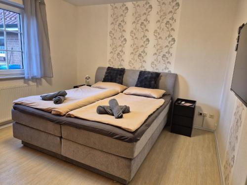 a bed with two pillows on it in a room at Feldblick in Krummhörn