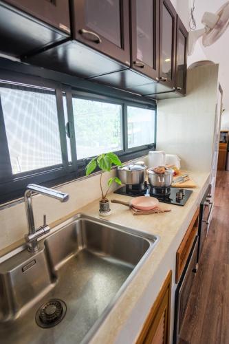 a kitchen with a sink and a counter top at Sam Lanta in Ko Lanta