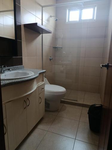 a bathroom with a toilet and a sink at Marina Breeze hotel in Manta