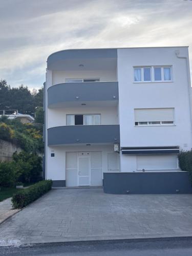 a large white house with a driveway at Apartments Silva in Split