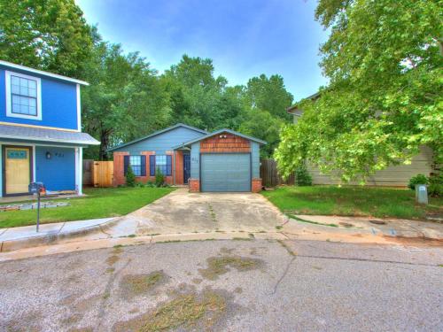 a house with a blue garage in the driveway at Oak & Elm 2BR King & Queen Edmond, OK in Edmond