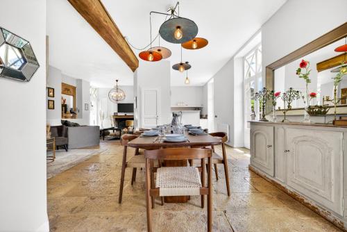 a dining room and living room with a table and chairs at Fanny à la Campagne in Nantoux