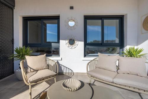 a patio with two chairs and a table at Paradise Resort 315 in San Miguel de Salinas