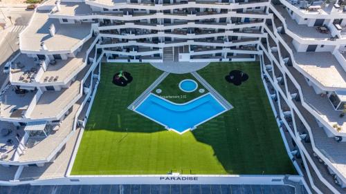 an aerial view of a large building with a pool at Paradise Resort 315 in San Miguel de Salinas