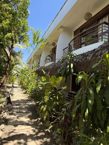 a building with a path in front of it at Happiness Beach Resort Siargao in General Luna