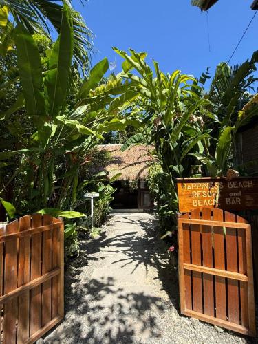a garden with a gate and some plants at Happiness Beach Resort Siargao in General Luna