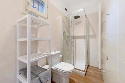 a white bathroom with a shower and a toilet at Casa 3 Rose Lake View and Pool in Toscolano Maderno