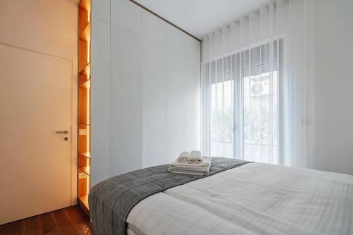 a bedroom with a bed and a large window at Adriatica sea view apartment in Baošići