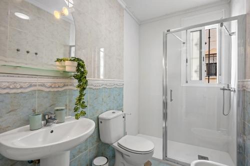a bathroom with a toilet and a sink and a shower at Casa Nemo in Rojales