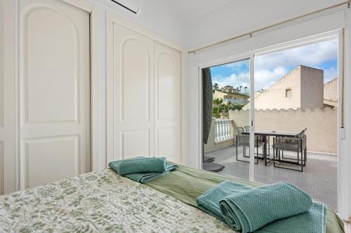 a bedroom with a bed and a view of a balcony at Casa Nemo in Rojales