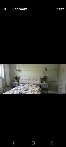 a bedroom with a bed and two night stands at Dunfolan House in Dundrum