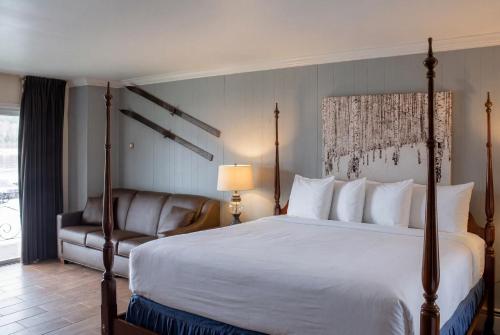 a hotel room with a bed and a chair at Gauthier's Saranac Lake Inn in Saranac Lake