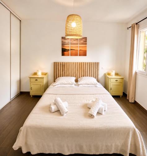 a bedroom with a large bed with towels on it at L'Alivi di l'Osari in Belgodère