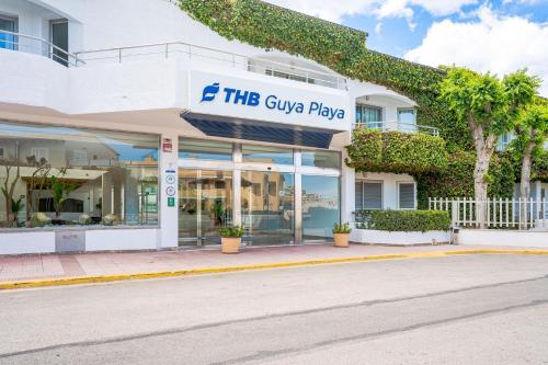 a building with a sign that reads the give package at THB Guya Playa in Cala Ratjada