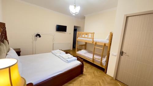 a small room with two bunk beds and a television at Davit's Apartments 21 in Tbilisi City