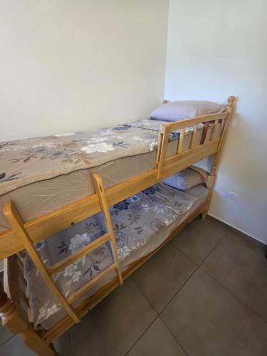 a wooden bunk bed in a room at Duplex en Luque in Zarate Isla