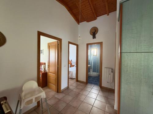 a bathroom with a walk in shower and a bedroom at Chalet privado playa de Boa in Noya