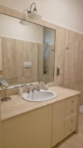 a bathroom with a sink and a mirror at Piccinni house in Bari