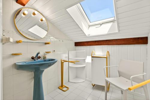 a bathroom with a sink and a mirror and a toilet at Villa Miroir in Publier
