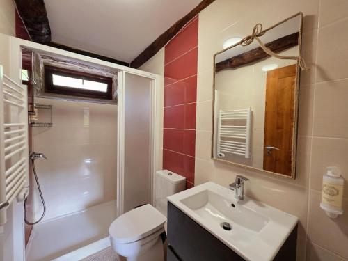 a bathroom with a sink and a toilet and a mirror at Casa Rio D'Além in Melgaço