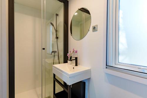 a bathroom with a sink and a mirror at Club del Sole Le Gorette Cecina Easy Camping Village in Marina di Cecina