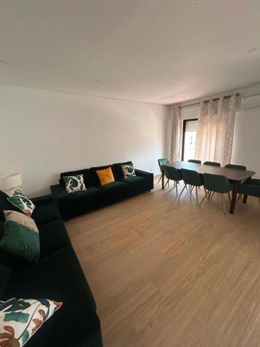 a living room with a couch and a table at Casa Rosarinho in Faro