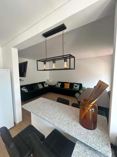 a living room with a table and a couch at Casa Rosarinho in Faro