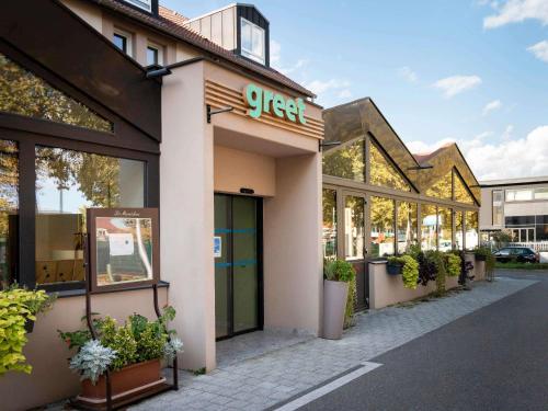a store with a sign on the front of it at Greet Hotel Colmar in Colmar