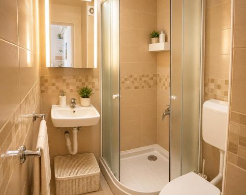 a bathroom with a shower and a sink at Apartments Mohar II in Baška