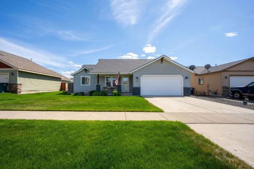 a house with a white garage and a driveway at Prairie Falls in Post Falls