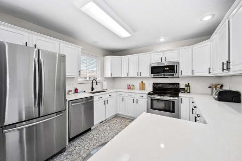 a kitchen with white cabinets and a stainless steel refrigerator at Prairie Falls in Post Falls