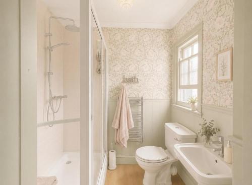 a bathroom with a toilet and a sink and a shower at 5 Bed in Hundleby oc-o44769 in Spilsby