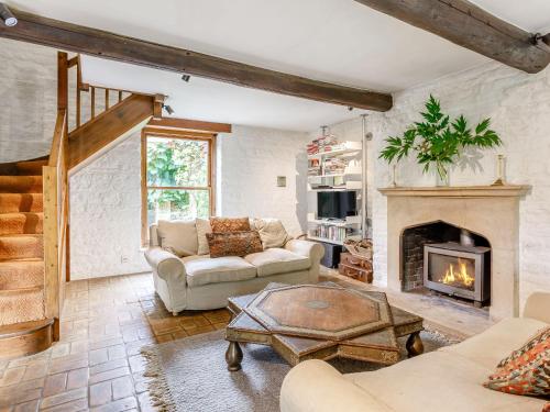 a living room with two couches and a fireplace at The Barn - Uk51594 in Grantham