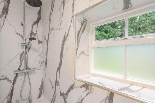 a bathroom with a shower and a window at 1 Bed in Exton oc-e42799 in Exton