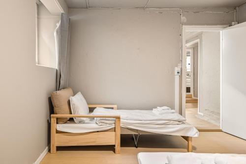 a room with a bed and a chair in it at Bergen Guesthouse in Bergen