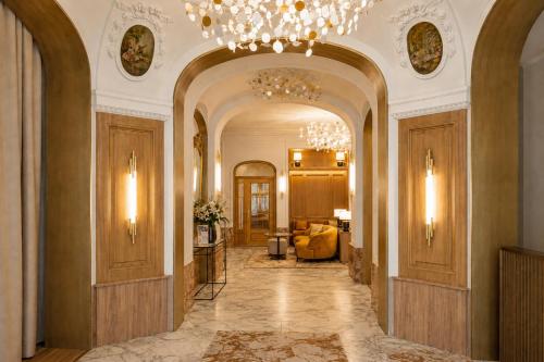 a hallway of a building with a chandelier at Grand Hotel Bellevue - Grand Place in Lille