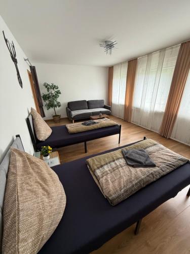 a living room with two beds and a couch at CAL Apartments in Duisburg