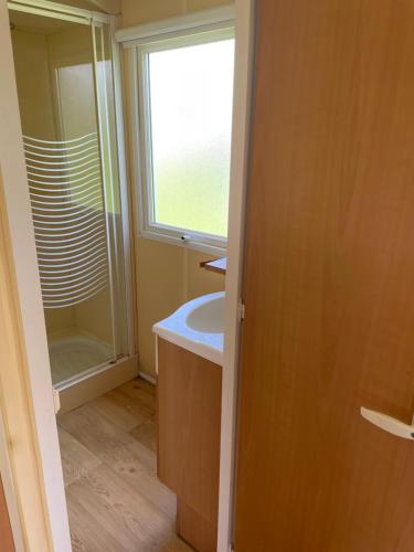 a bathroom with a sink and a window at Chez Elisa et Fabien in Canet-de-Salars