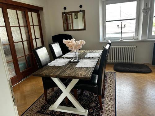 a dining room table with black chairs and a wooden table at Byt Staré Mesto in Liptovský Mikuláš