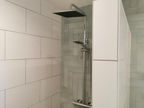 a shower with a glass door in a bathroom at Fleurs et Abeilles in Faye-lʼAbbesse