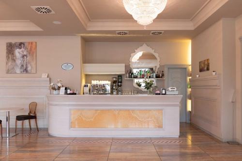 a bar in a room with a counter at Grand Hotel Forlì in Forlì