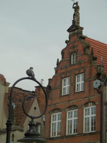 a brick building with a tower on top of it at Apartament MARIA in Gdańsk