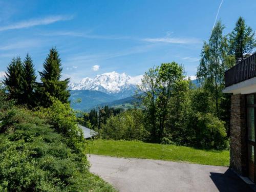 a view of a snow covered mountain from a driveway at Résidence La Grande Cordée - Combloux in Combloux