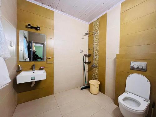 a bathroom with a toilet and a sink at Haven Daisy Meadows - 2BR Cottage with Lawn in Changla Gali in Chhāngla Gali