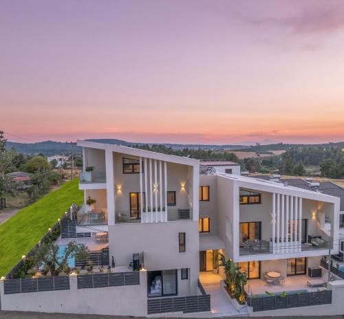 an image of a building with the sunset in the background at Calista Horizon by Booking Kottas in Kallithea Halkidikis