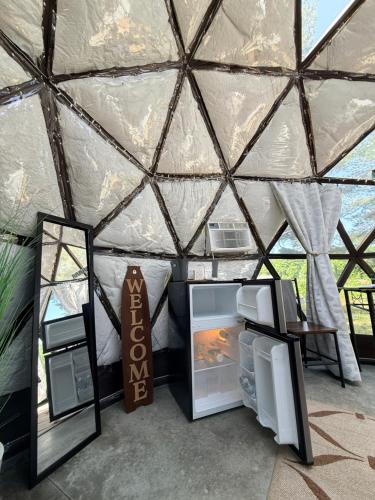 an interior view of a yurt with a refrigerator at Dome Haven Glamping in South Haven
