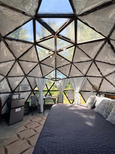 a bedroom in a dome tent with a bed in it at Dome Haven Glamping in South Haven