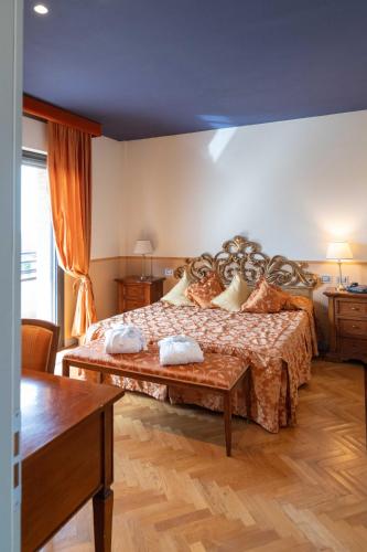 a bedroom with a large bed in a room at Grand Hotel Forlì in Forlì