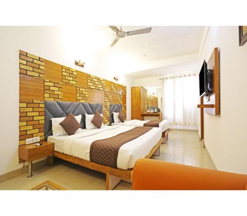 a bedroom with two beds and a television in it at Royal with - Group Name Hotel Double R- comfort stay in Main Bazar New Delhi in New Delhi